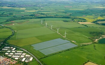 Wind turbines and solar farms are taking up land previously occupied by food-producing farmers