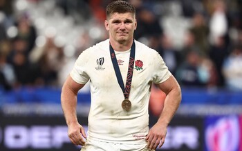 England's fly-half and captain Owen Farrell reacts during the medal ceremony after winning the France 2023 Rugby World Cup third-place match between Argentina and England at the Stade de France in Saint-Denis